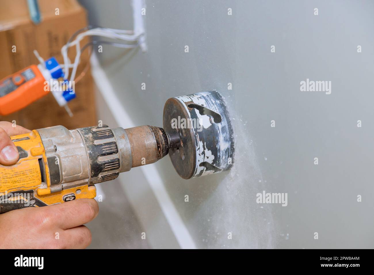 An electrical wire has to be installed in wall by drilling hole in