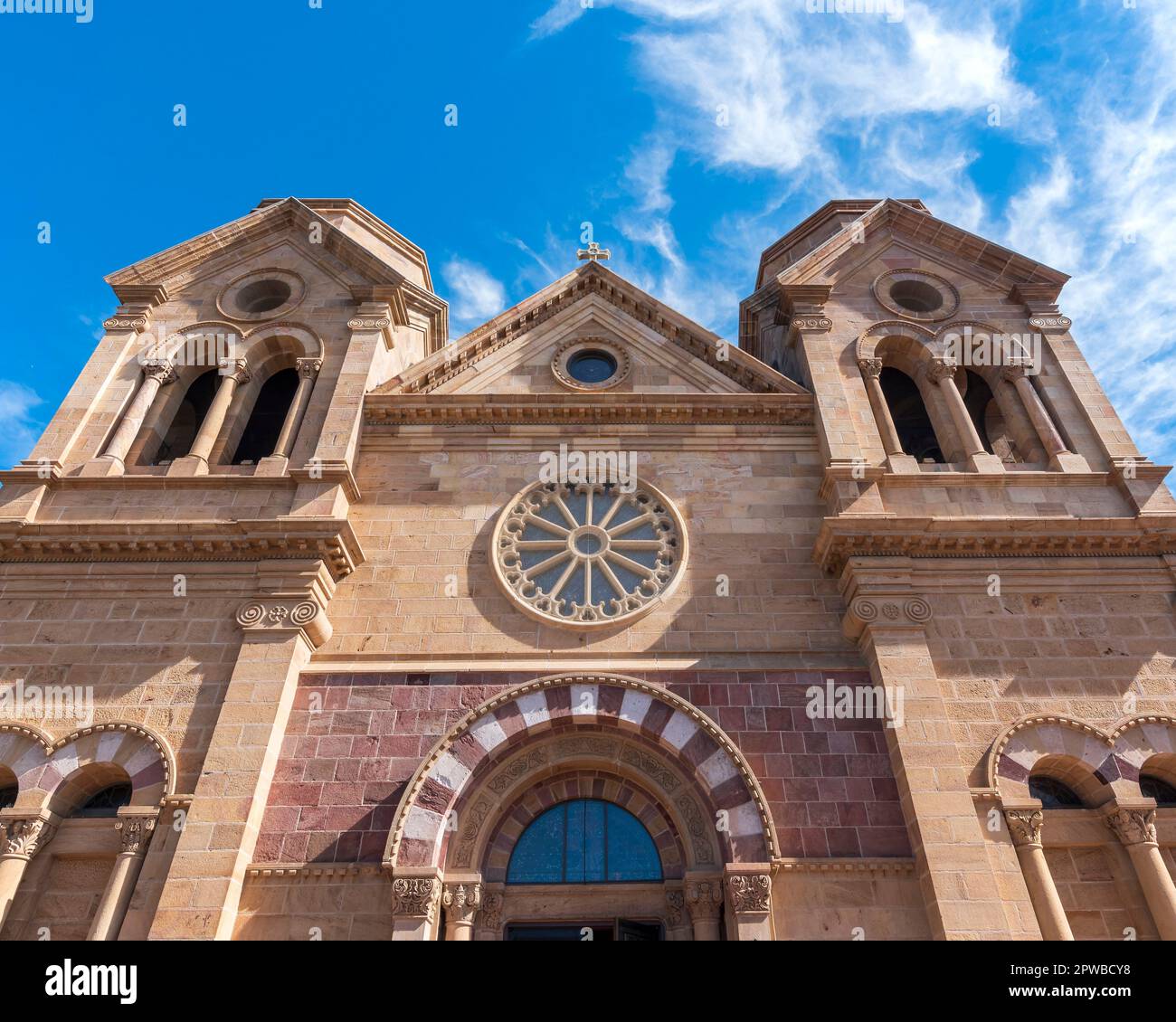 Horizontal image of the front facade of the Cathedral Basilica of St. Francis of Assisi in Santa Fe, New Mexico, with rose window and towers. Stock Photo