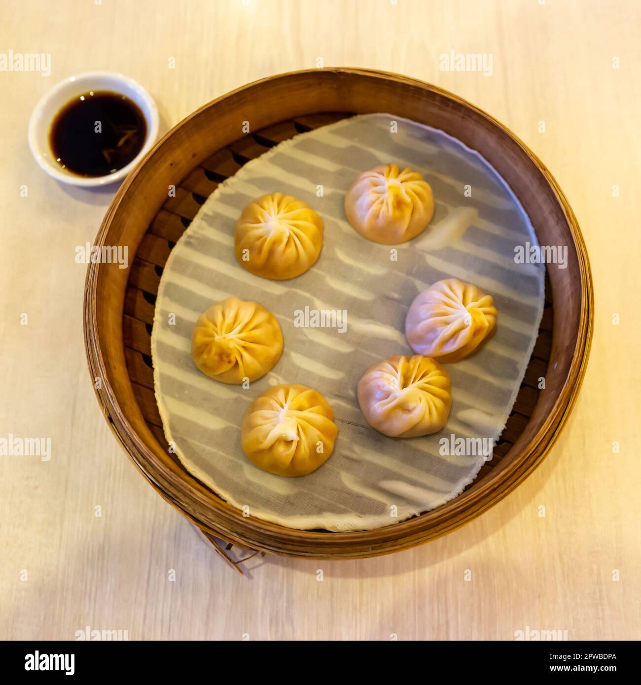 Shrimp and Pork soup dumplings with soy sauce served at Xiao Long Bao