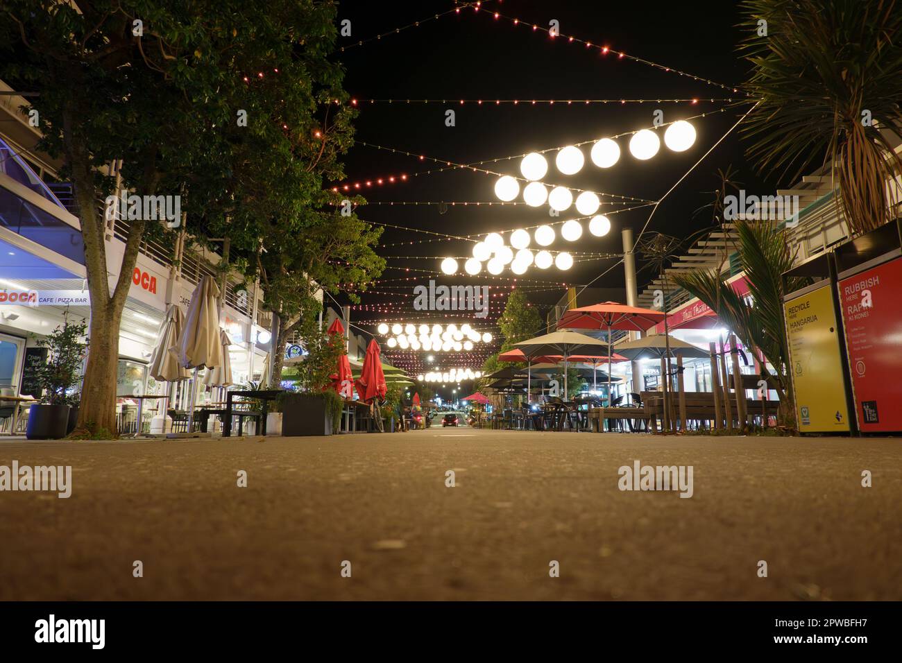 Tauranga New Zealand - April 27 2023; Tauranga street at night with lights and darkness in Wharf Street dining precinct. Stock Photo