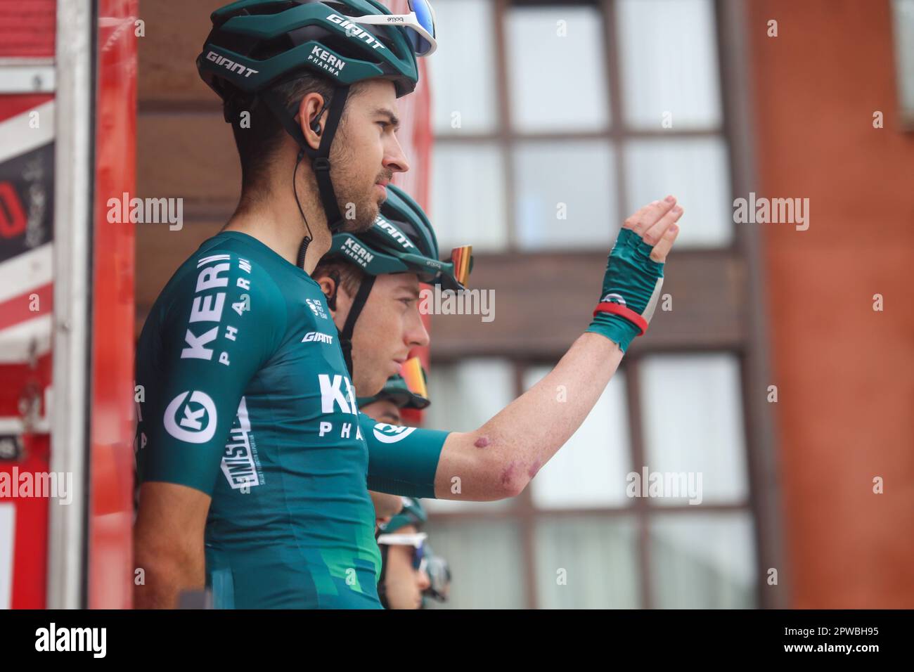 Candas, Spain, 29th April, 2023: Kern Pharma Team rider Roger Adria (R) waves as Hector Carretero looks on at the presentation during the 2nd stage of the Vuelta a Asturias 2023 between Candas and Cangas del Narcea, on April 29 2023, in Candas, Spain. Credit: Alberto Brevers / Alamy Live News Stock Photo