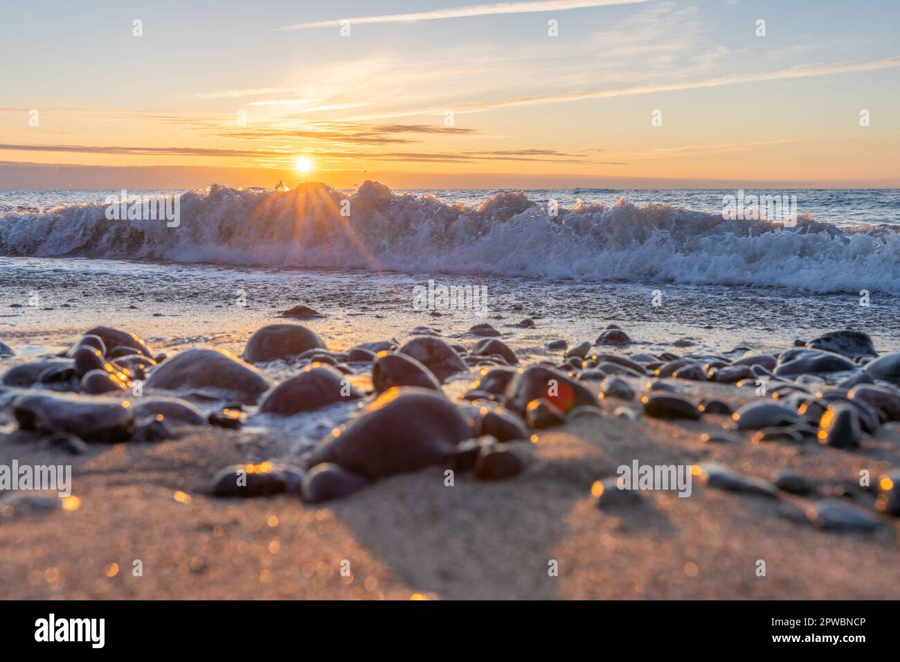 dreamlike, orange, sunset between rocks in the sea of the Baltic Sea ...