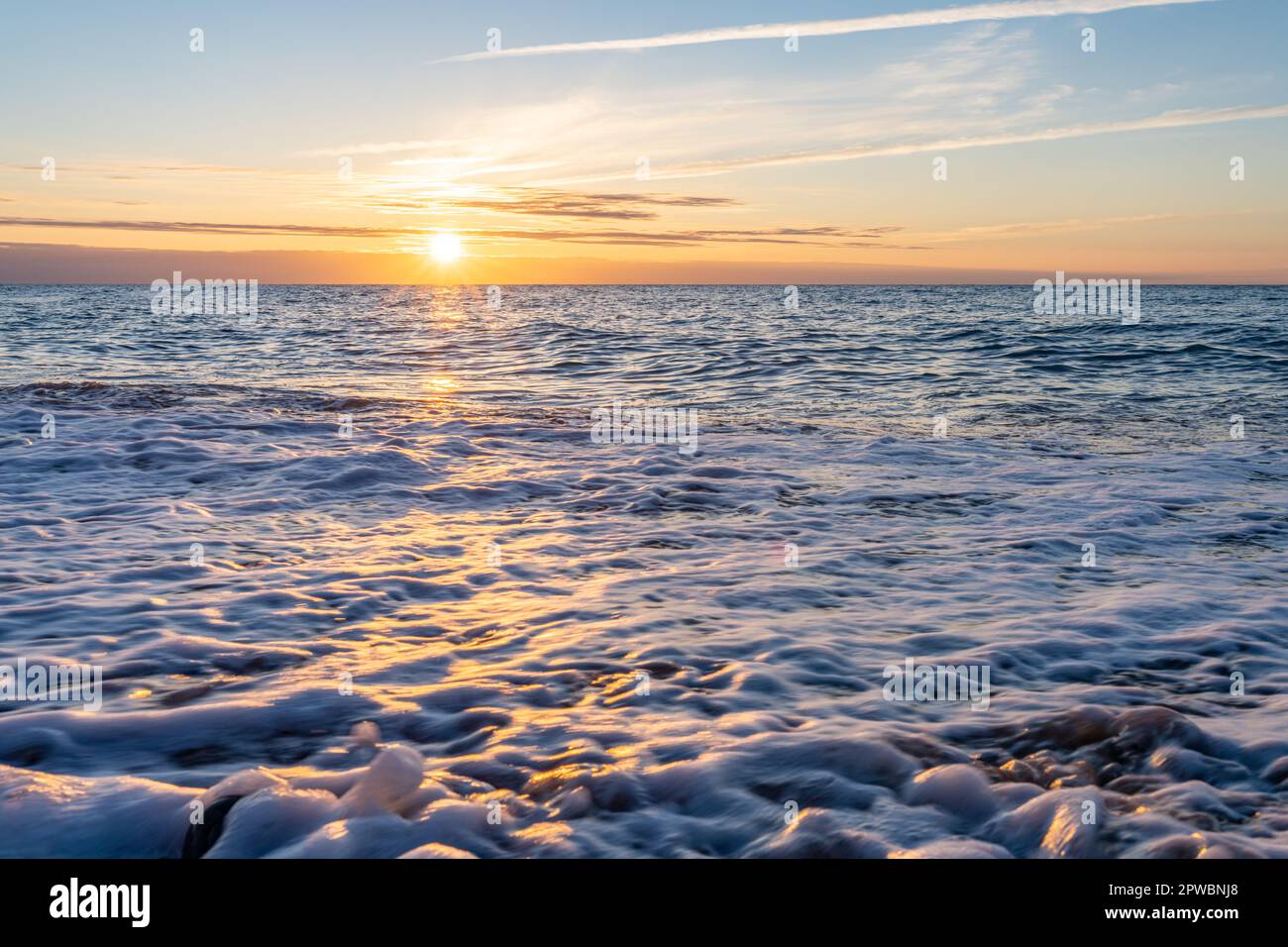 dreamlike, orange, sunset between rocks in the sea of the Baltic Sea ...