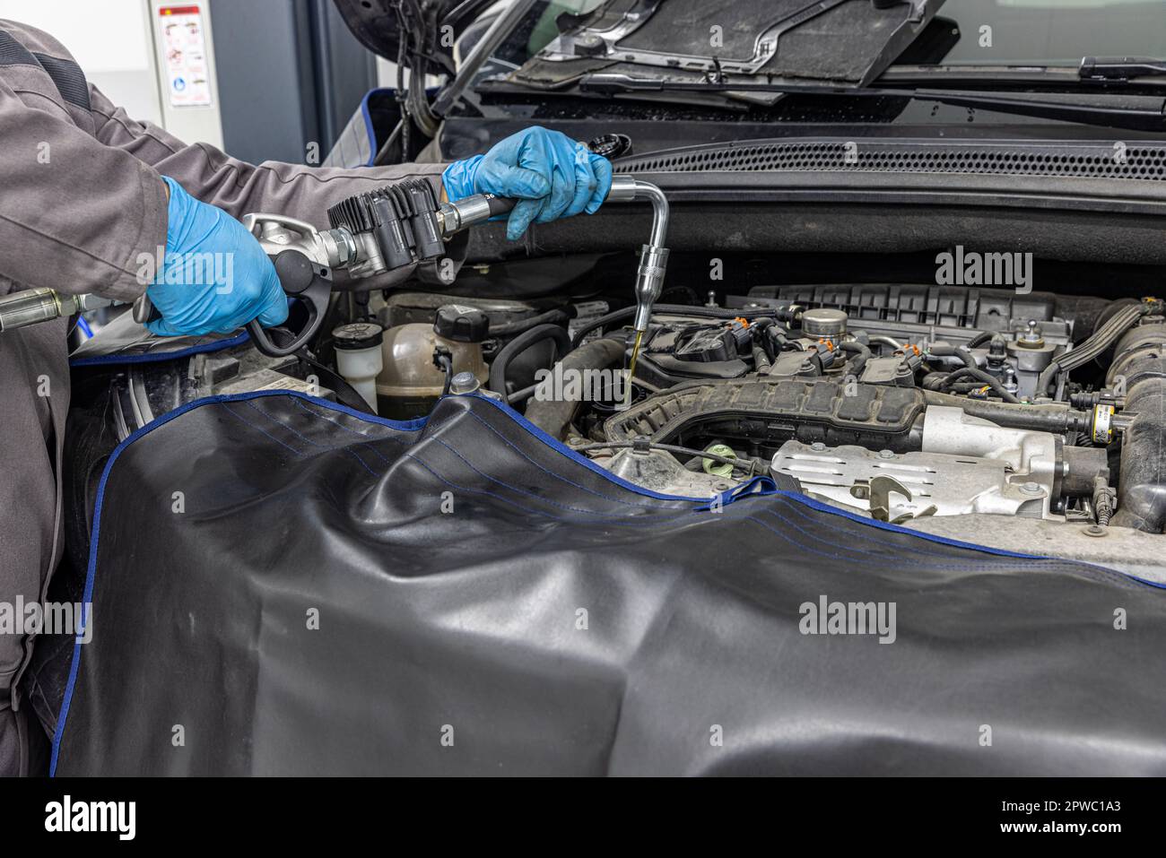 Engine oil filling in the car service. Maintenance in a car service