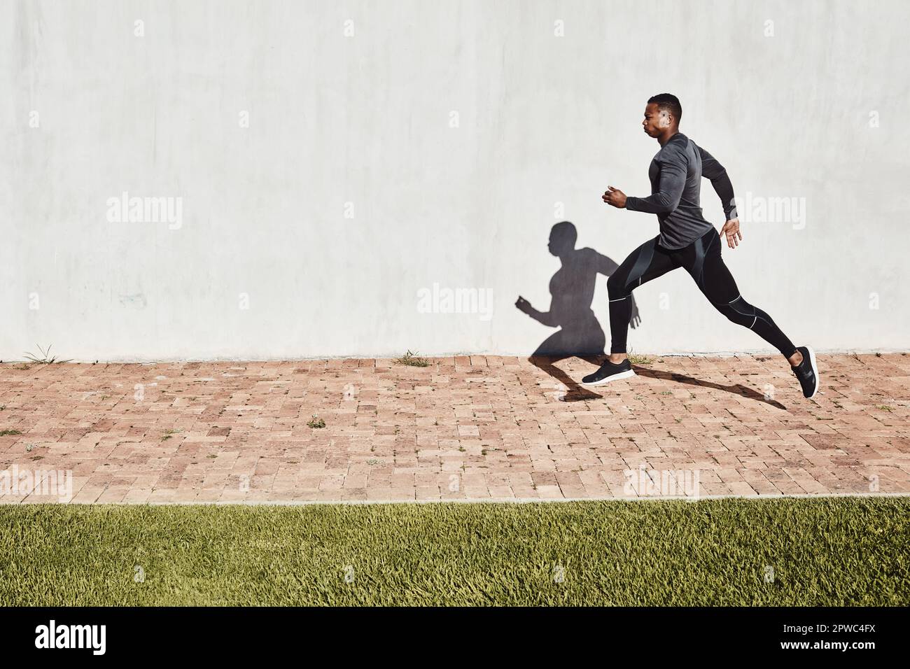 Training for the big run. Full length shot of a handsome and athletic ...