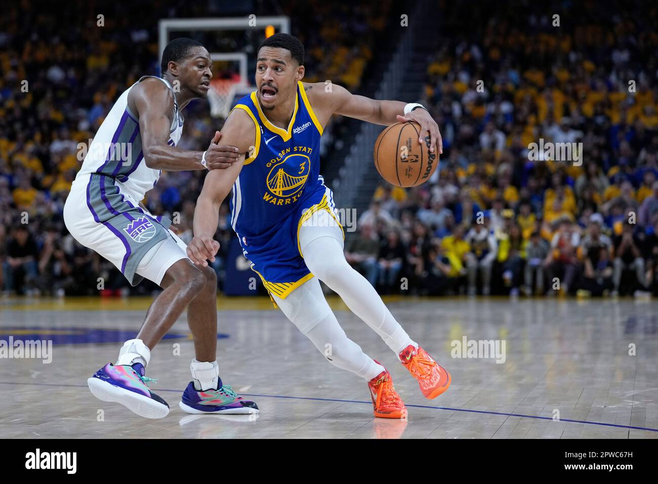 Golden State Warriors guard Jordan Poole, right, tries to get past  Sacramento Kings guard De'Aaron Fox, let, during the second half of Game 6  of a first-round NBA basketball playoff series in