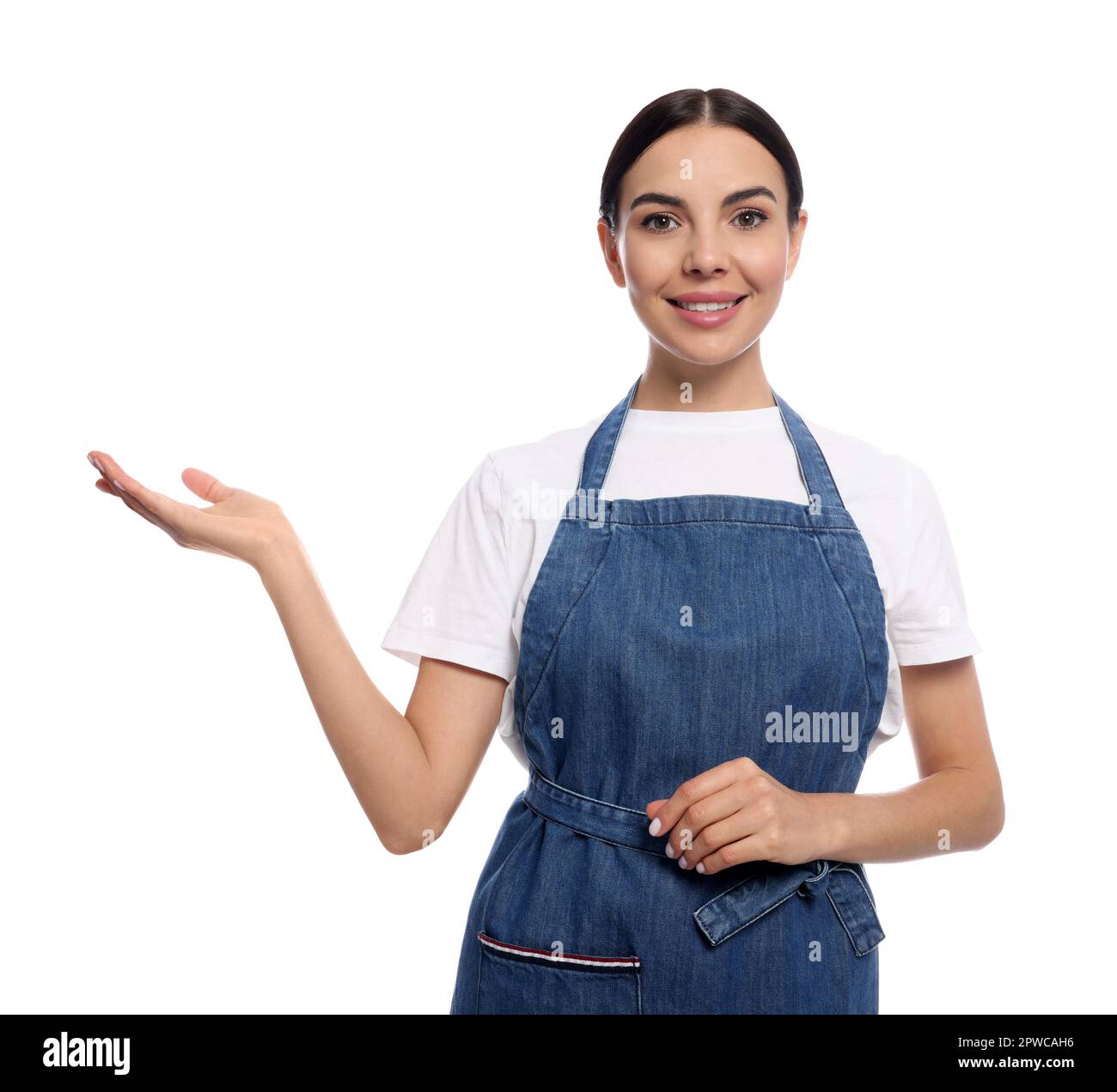 Young woman in blue jeans apron on white background Stock Photo - Alamy