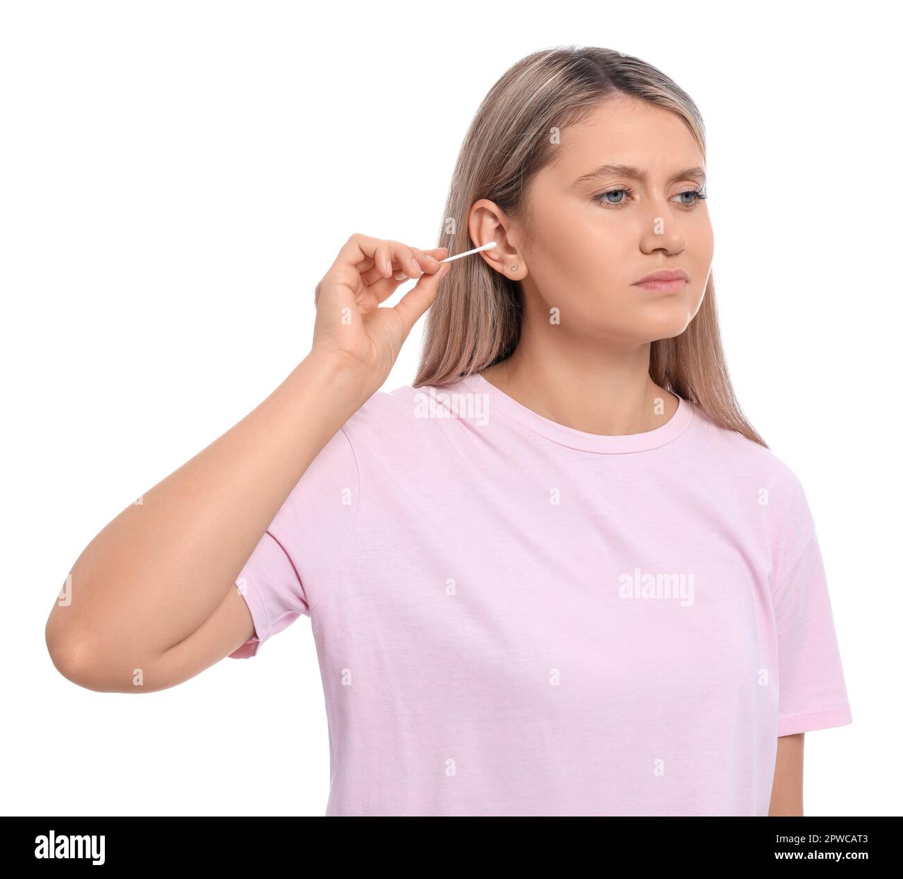 Young woman cleaning ear with cotton swab on white background Stock
