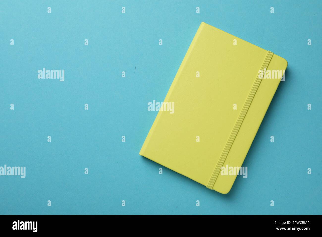 New stylish planner with hard cover on light blue background, top view. Space for text Stock Photo