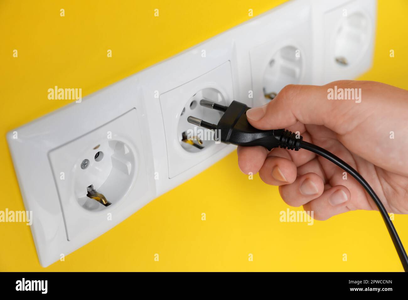 Closeup hand inserting electrical plug hi-res stock photography and ...