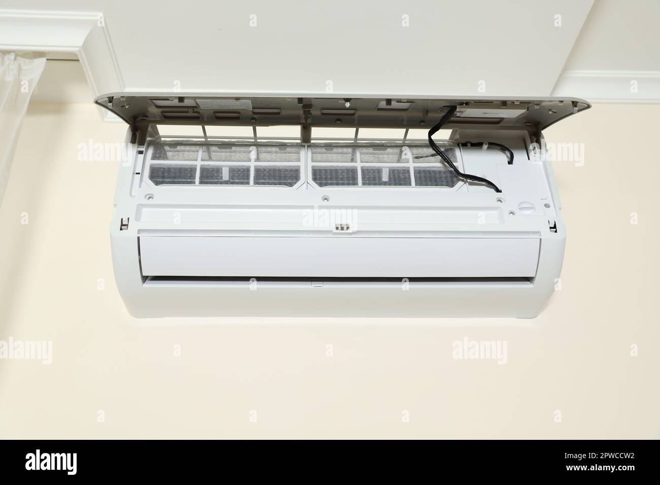 Modern air conditioner on white wall indoors Stock Photo - Alamy