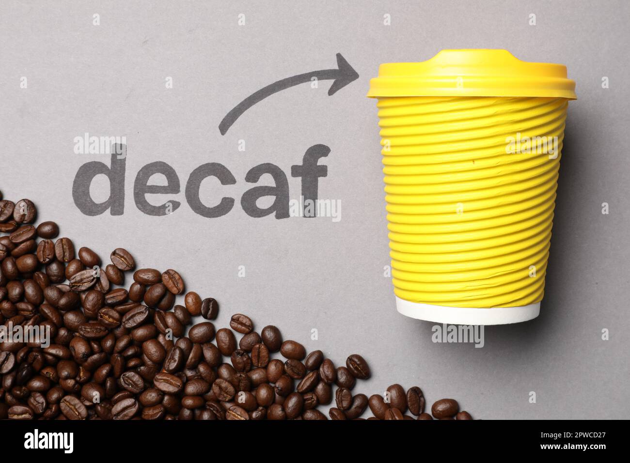 Coffee beans, word Decaf and arrow pointing at takeaway paper cup on ...