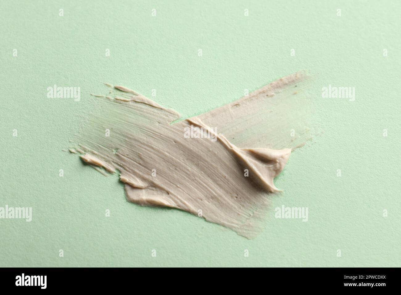 Sample of face mask on light green background, top view Stock Photo
