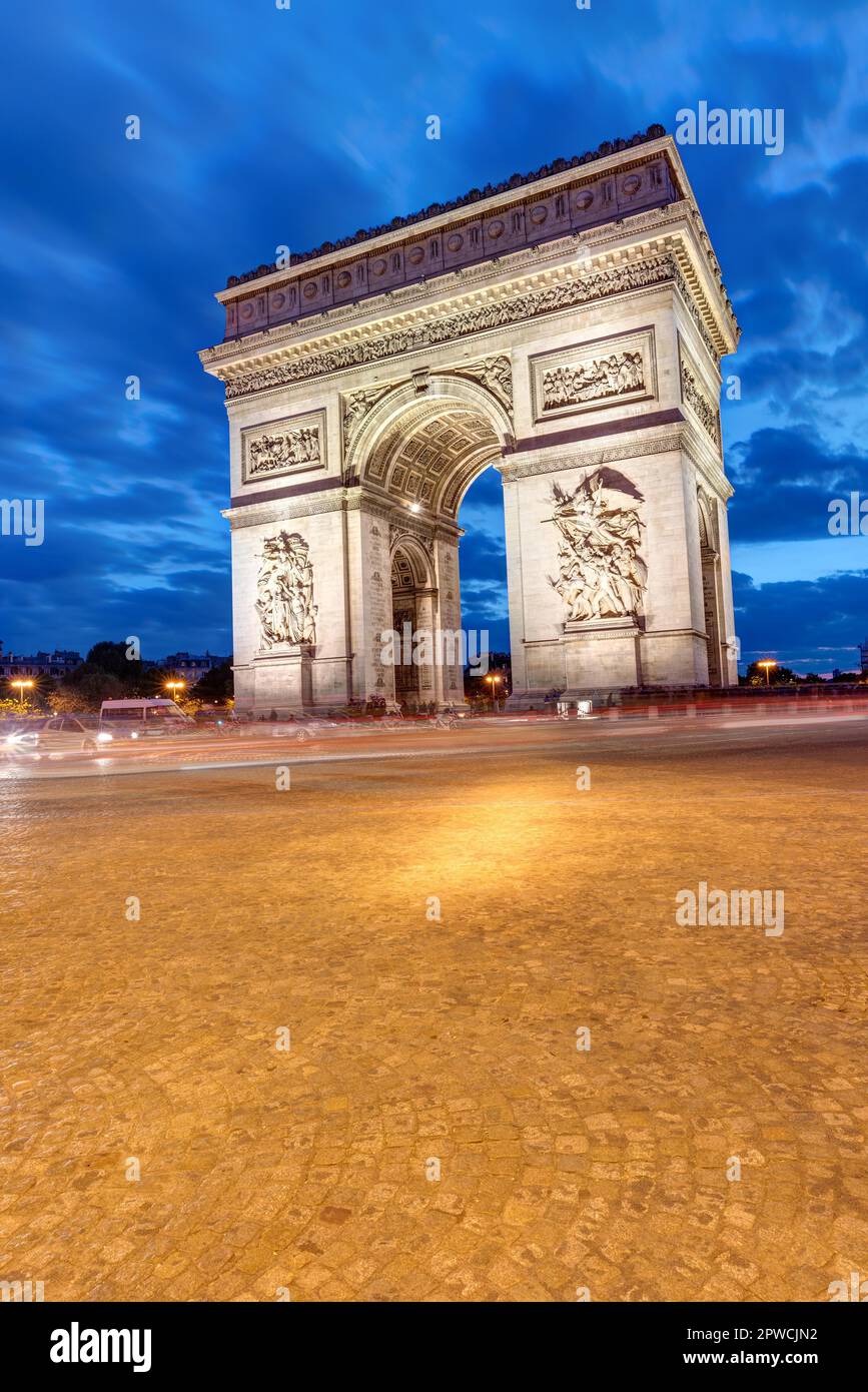 The famous Arc de Triomphe in Paris by night Stock Photo