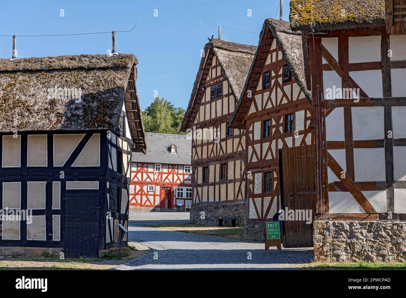 Historic halftimbered houses, farms on cobbled street, Hessenpark OpenAir Museum, NeuAnspach