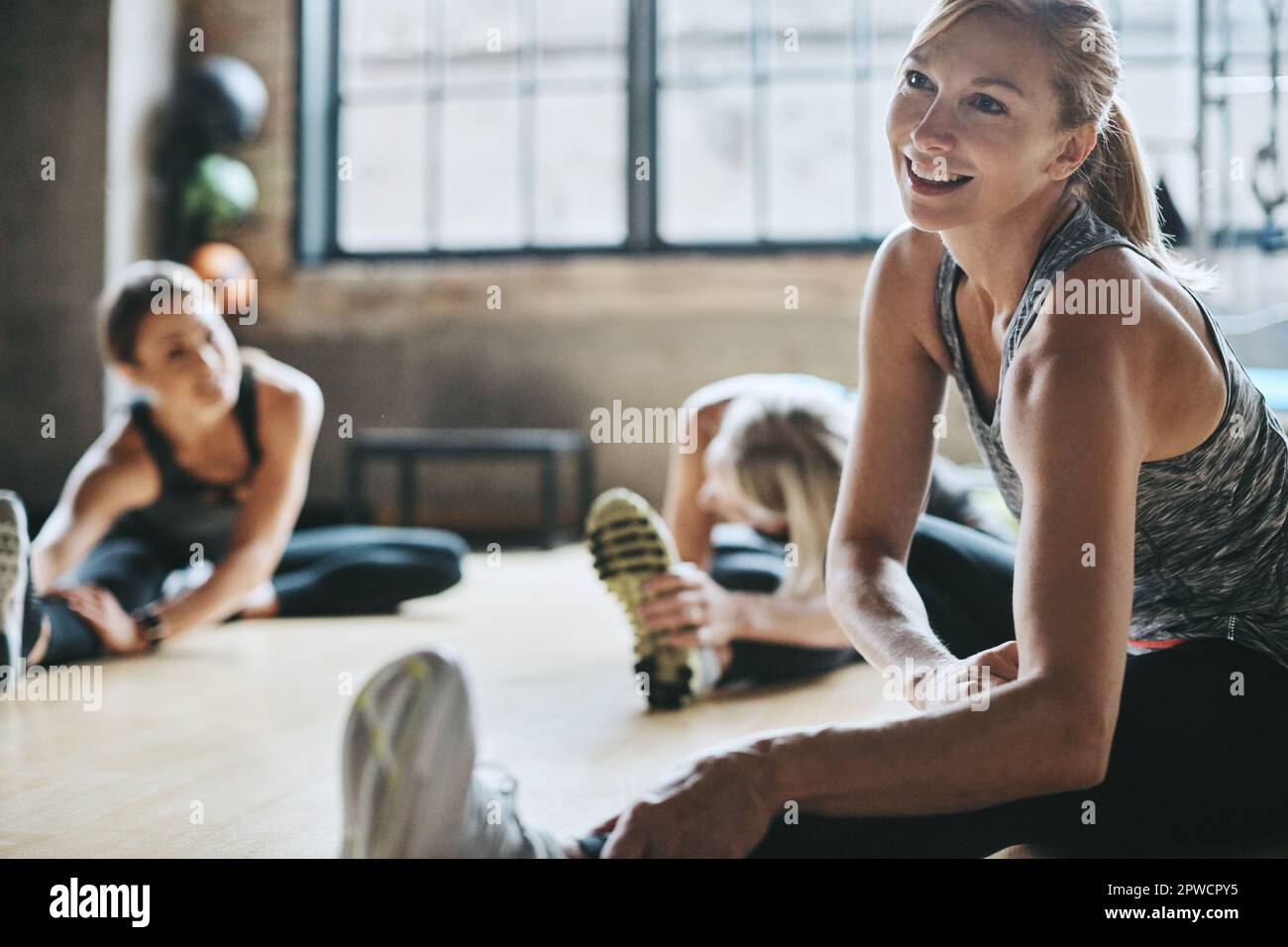 The best place to get fit. mature women stretching with a young female  instructor during a training class at the gym Stock Photo - Alamy