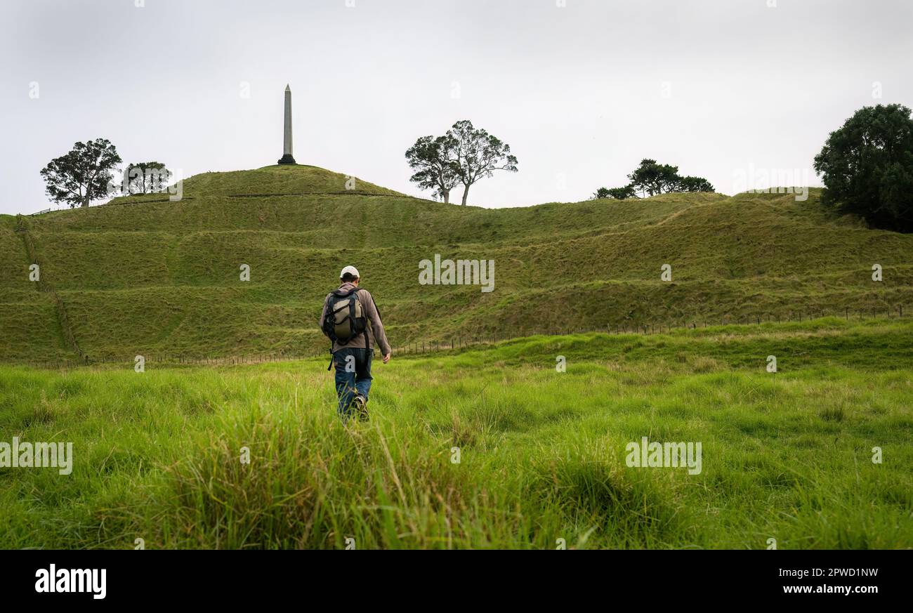 Tourist walking towards the Tower at One Tree Hill. Auckland. Stock Photo