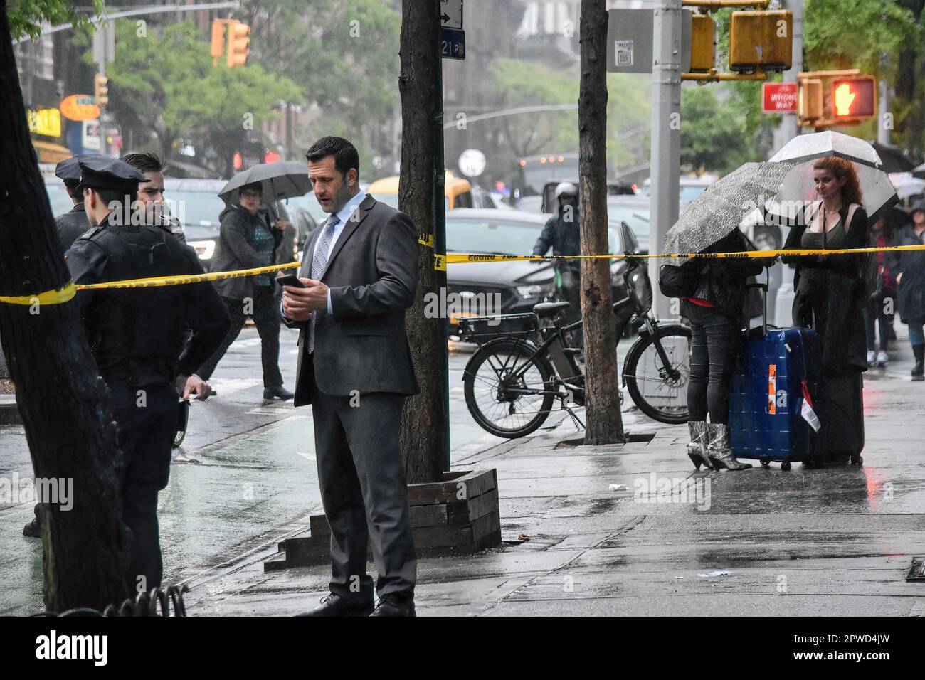 Manhattan, United States. 29th Apr, 2023. A man is showing a police officer some details on the phone during the investigation. Police investigate the shooting incident. Shooting in Manhattan, New York, United States on April 29, 2023. At 17:43 Saturday evening one person was shot in the hip and shoulder near the area of 9th Avenue and West 46th Street. According to the New York City Police Department, the person shot is in stable condition. No suspects are captured at this time. (Photo by Kyle Mazza/SOPA Images/Sipa USA) Credit: Sipa USA/Alamy Live News Stock Photo