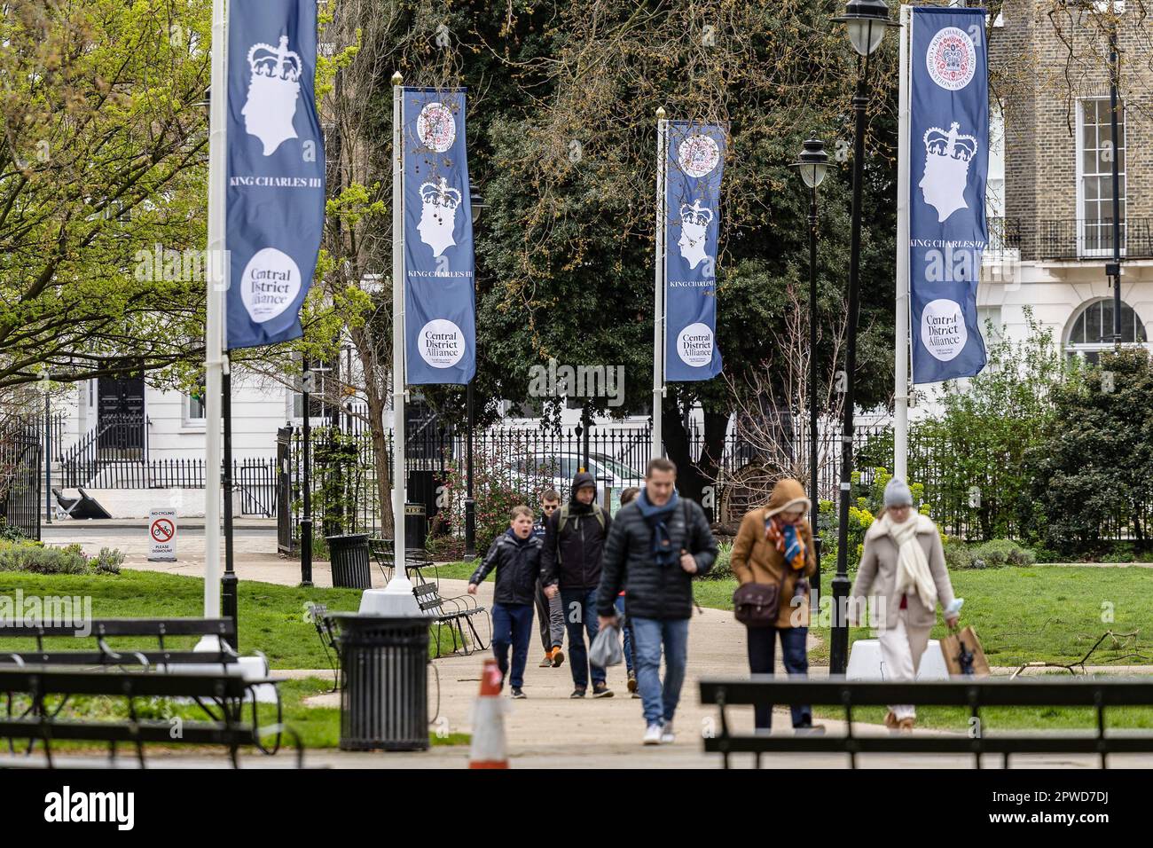London UK 12th Apr 2023 People Walk Past The Flag Of King Charles london-uk-12th-apr-2023-people-walk-past-the-flag-of-king-charles