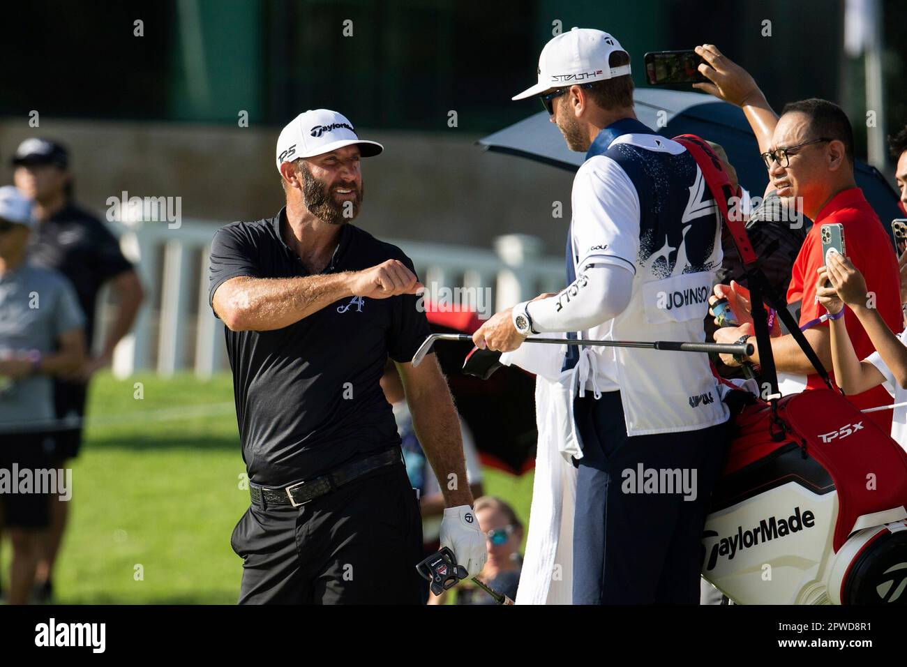 Captain Dustin Johnson of 4Aces GC fist bumps his caddie during the final round of LIV Golf