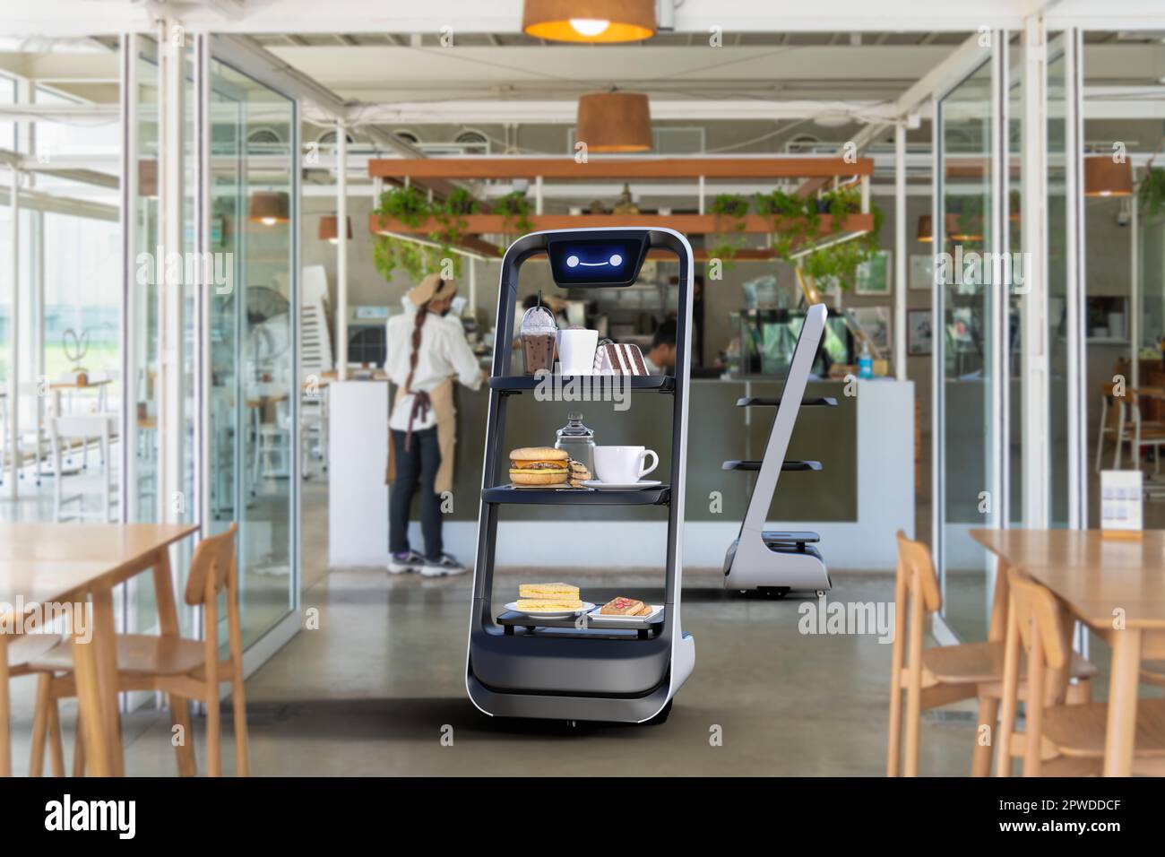 Autonomous waiter robot working in restaurant, Artificial intelligence 5G technology concept Stock Photo