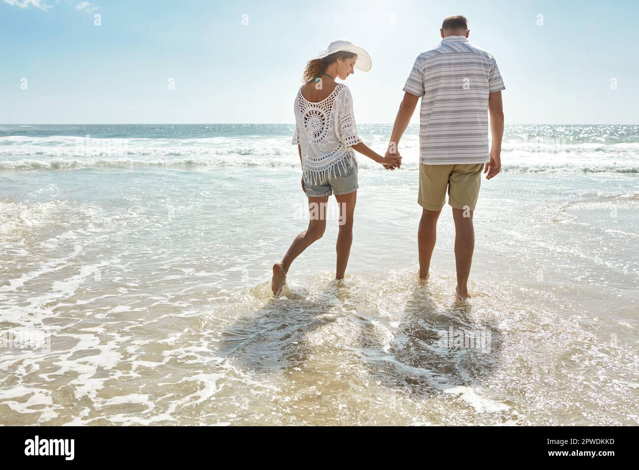 Summertime strolls. a mature couple walking along the beach Stock Photo ...