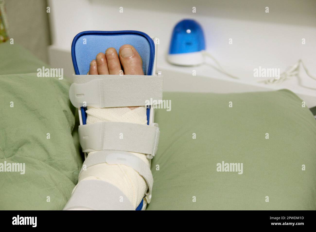 Concept of bandaging and treating an ankle injury at home Stock Photo