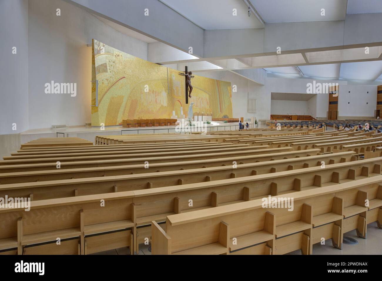 Fatima, Portugal - August 15, 2022: Altar of Basilica of the Holy Trinity showing altar, cross, mosaic, pews and tourists Stock Photo