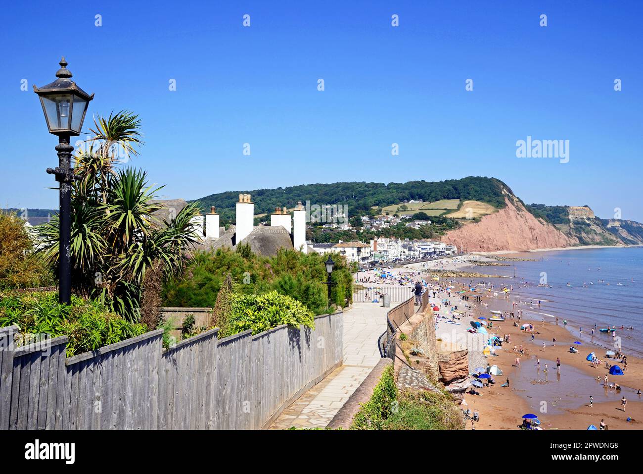 Elevated view along the beach with views of the town and Pennington Point cliffs seen from Jacobs Ladder, Sidmouth, Devon, UK. Stock Photo