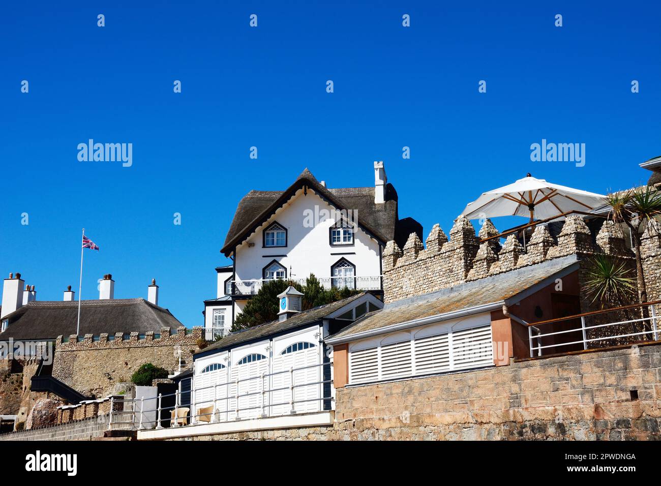 View of a traditional thatched houses overlooking the beach, Sidmouth, Devon, UK, Europe. Stock Photo