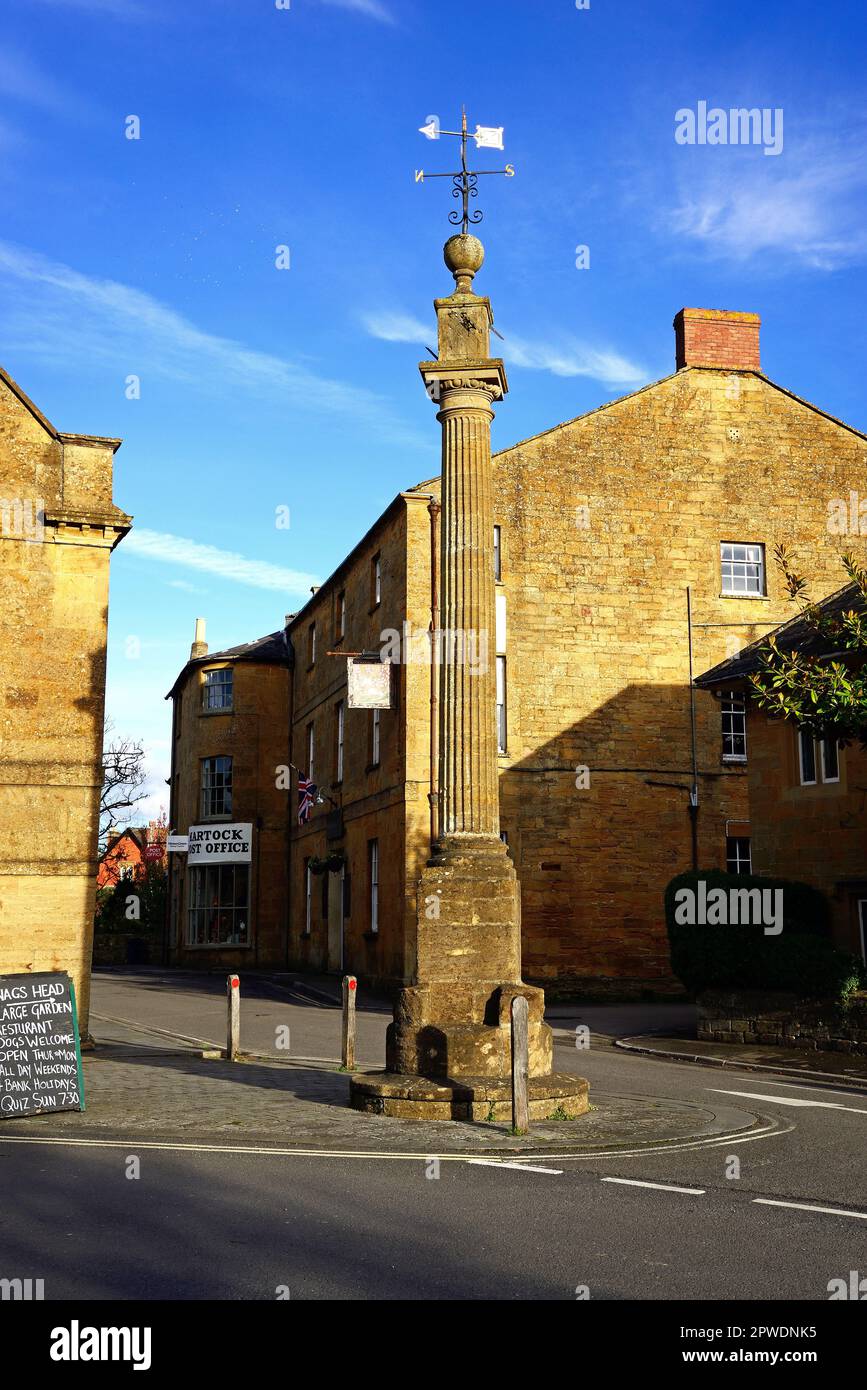 View of the Tuscan Order Column between the Market House and the White Hart Hotel along Church street in the village centre, Martock, UK. Stock Photo