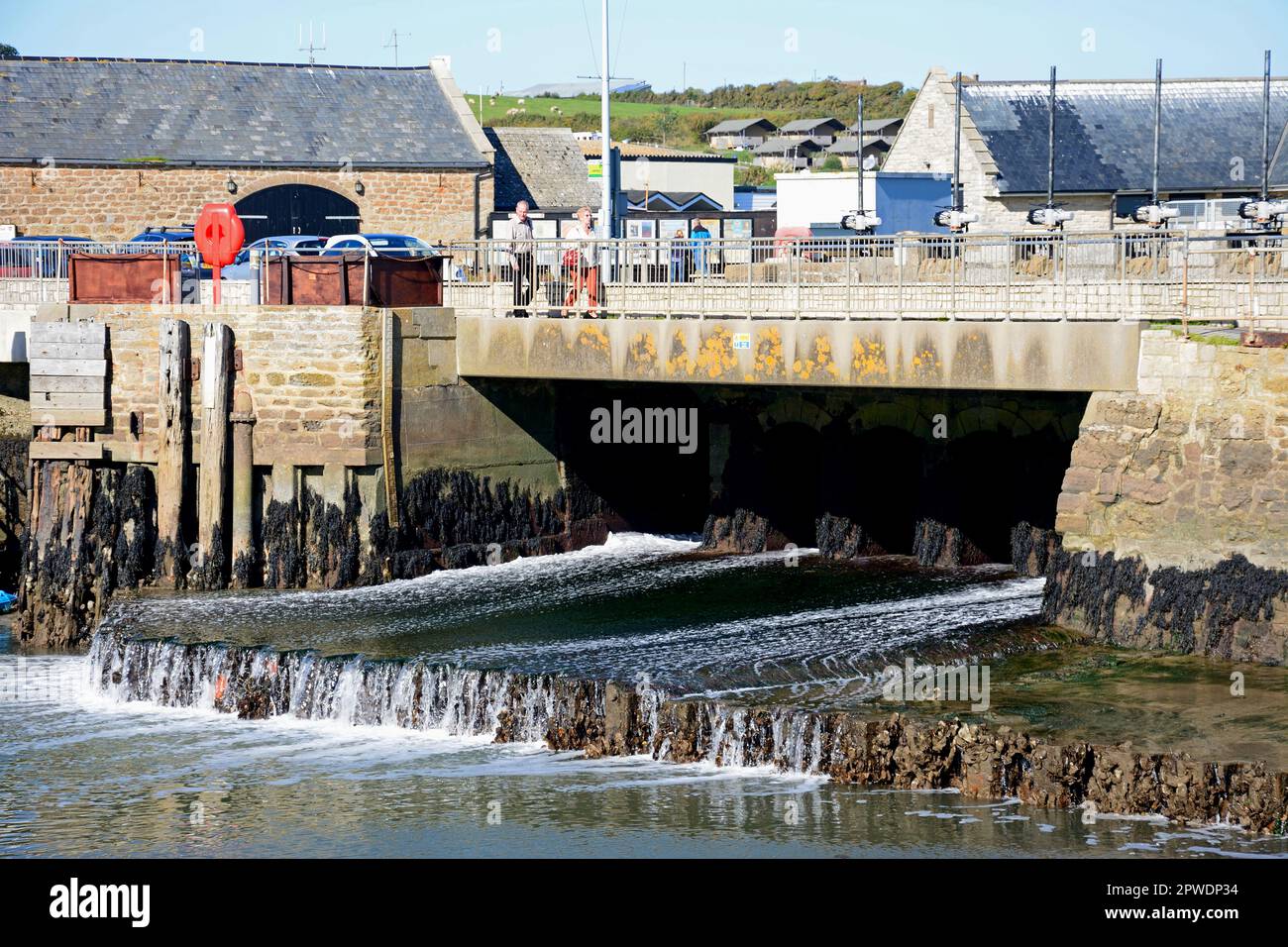 View of the sluice gate in the harbour at low tide, West Bay, Dorset, UK, Europe. Stock Photo