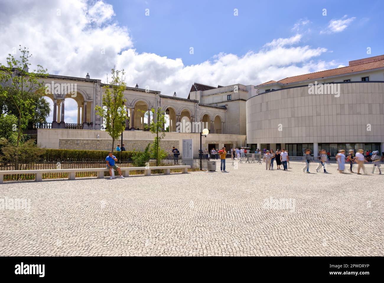 Fatima, Portugal - August 15, 2022: Surround of Sanctuary of Our Lady of the Rosary of Fatima Basilica with arches and numerous motion blurred tourist Stock Photo