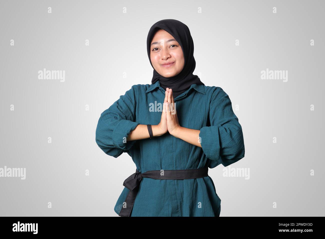 Portrait of cheerful Asian woman hijab in casual shirt, showing ...
