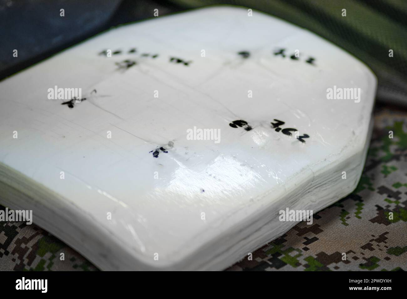 A depiction of the solid metal or ceramic plates installed in bulletproof vests for defense