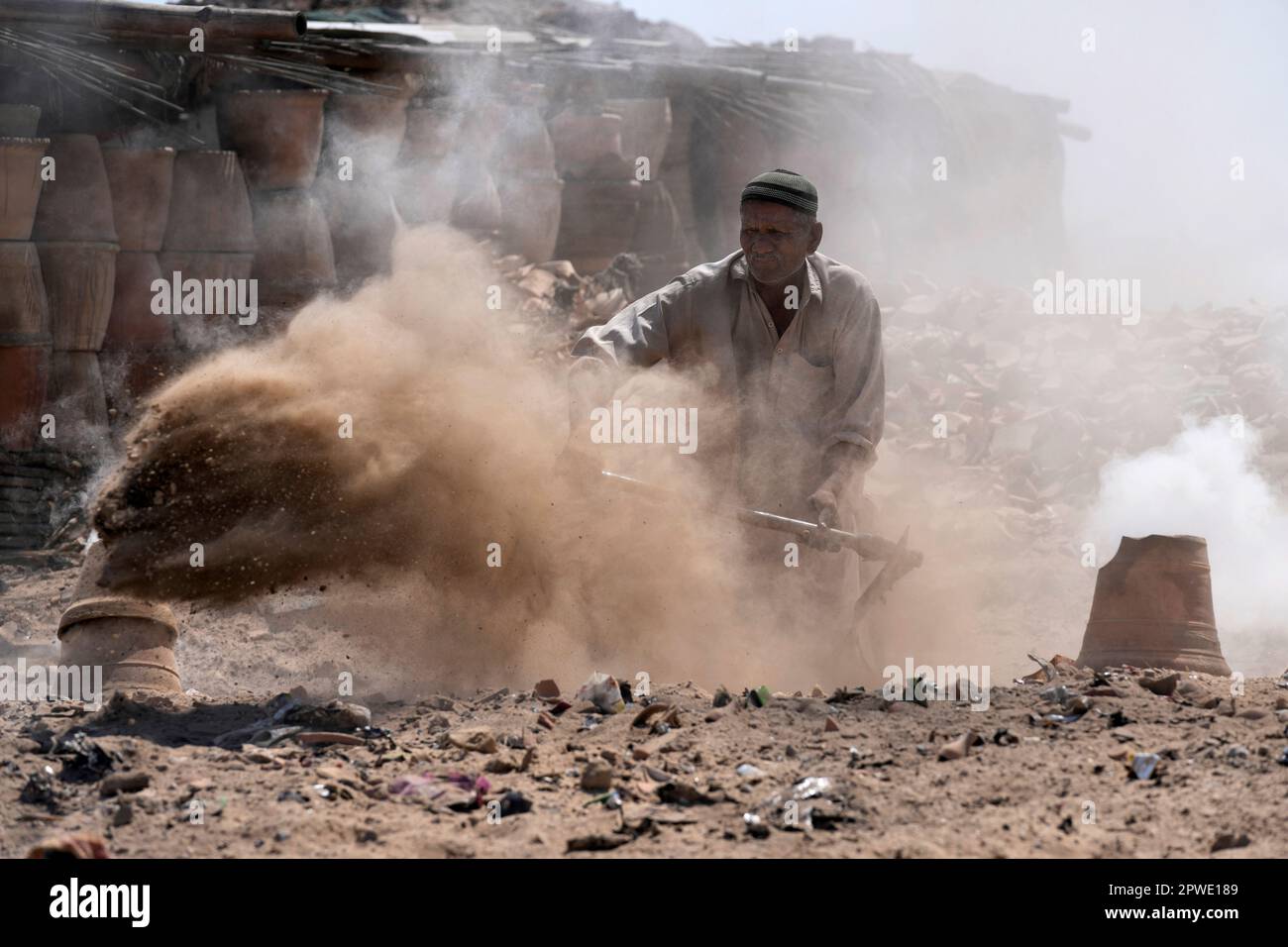 A Pakistani man works in making clay pots in Karachi, Pakistan, Sunday