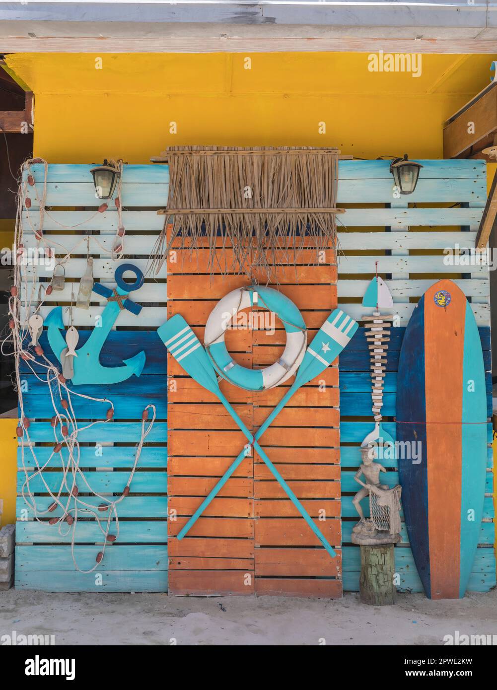 Thematic corner on the wall from a life buoy, oars and an anchor Stock