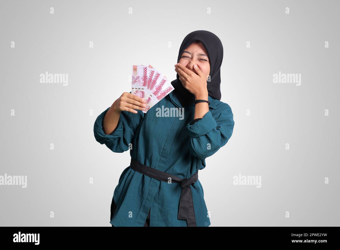 Portrait of excited Asian hijab woman in casual outfit showing one ...