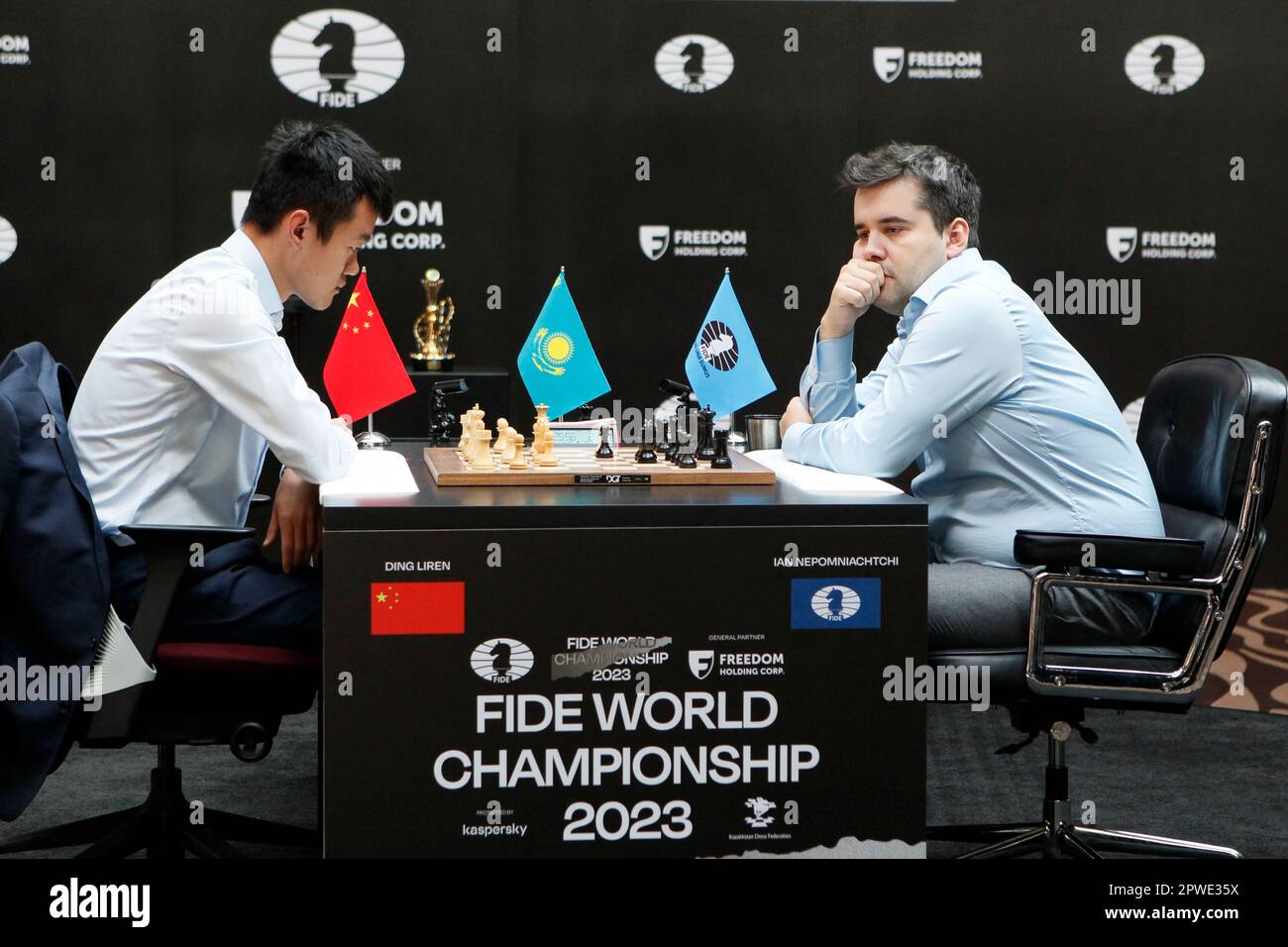 Russia's Ian Nepomniachtchi, right, and China's Ding Liren play during