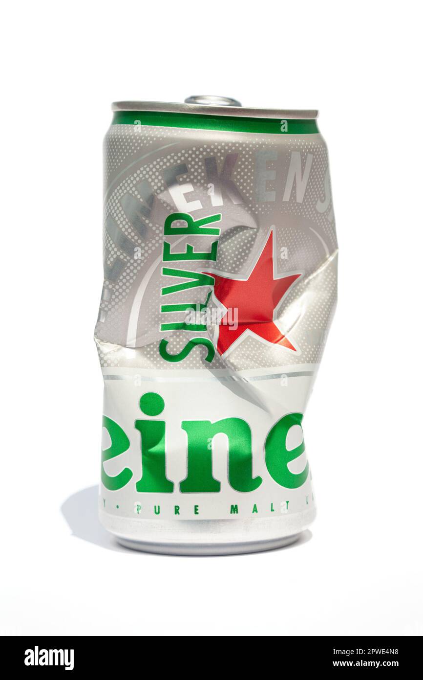 Ho Chi Minh City, Vietnam - April 30, 2023: Crushed aluminum beer can with the Heineken logo isolated on white. Opened empty crumpled can of a famous Stock Photo