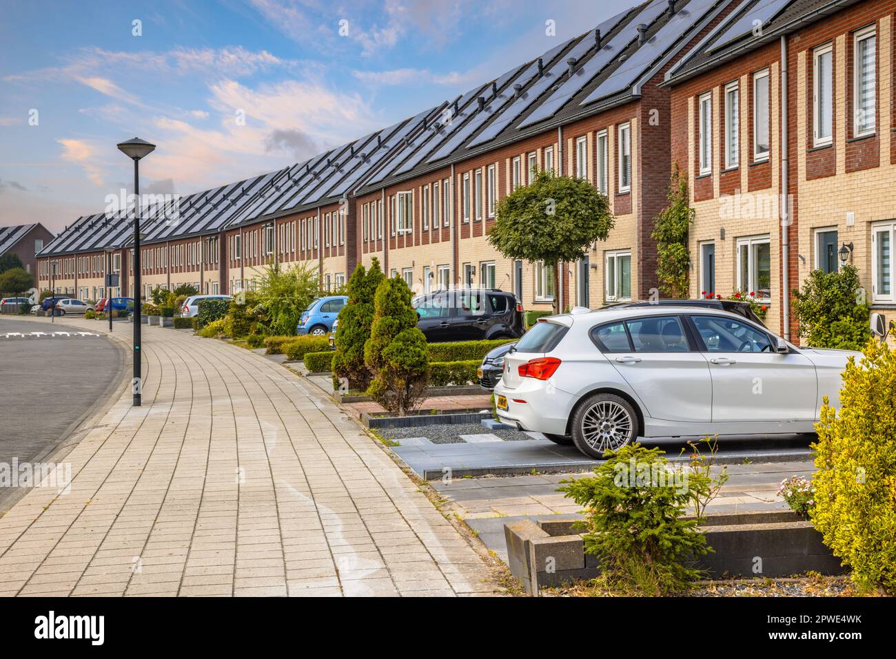 Row of modern houses in curved street. Contemporary neighborhood with