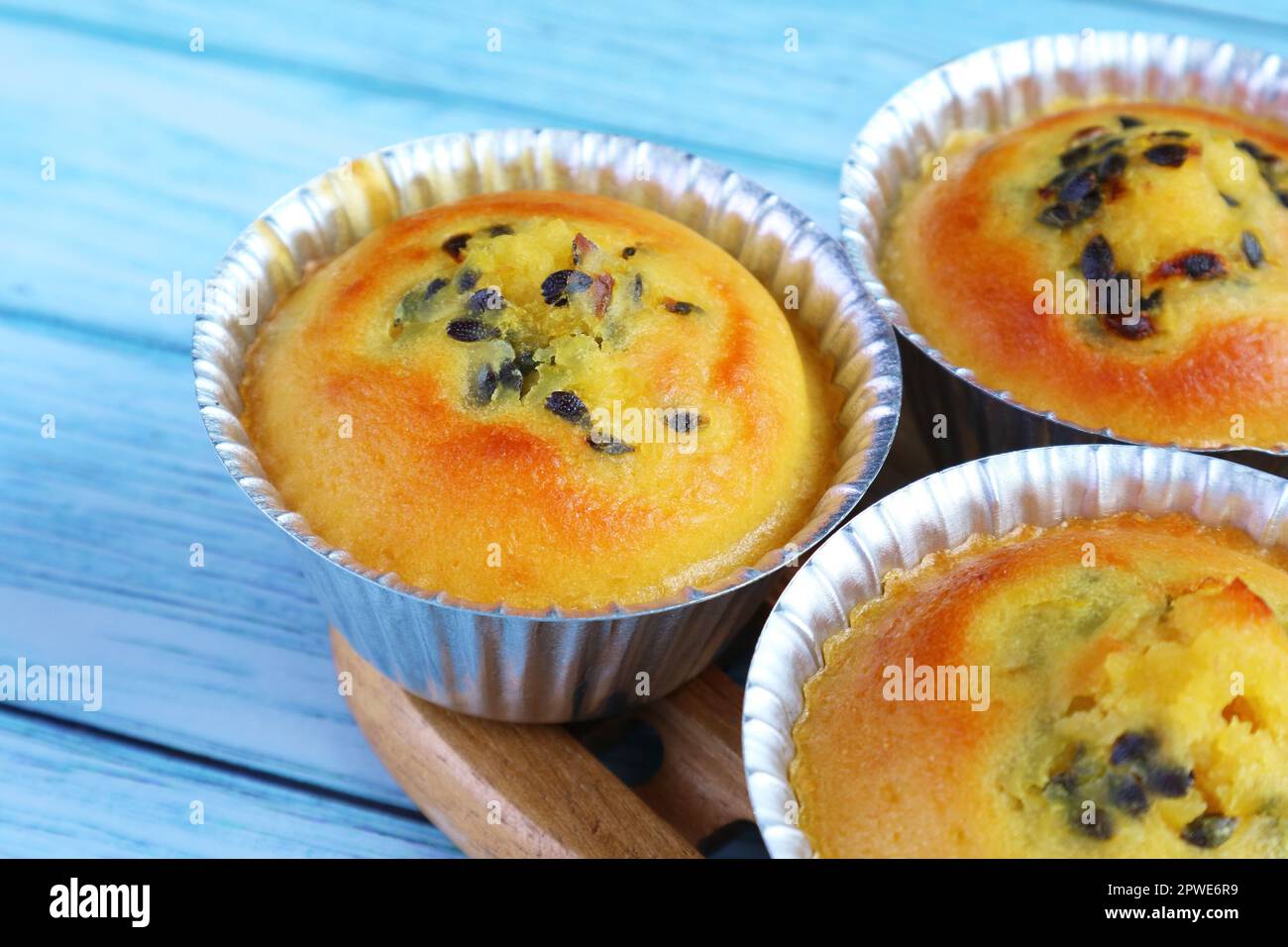 Closeup of Mouthwatering Freshly Baked Passion Fruit Muffins in Molds Stock Photo