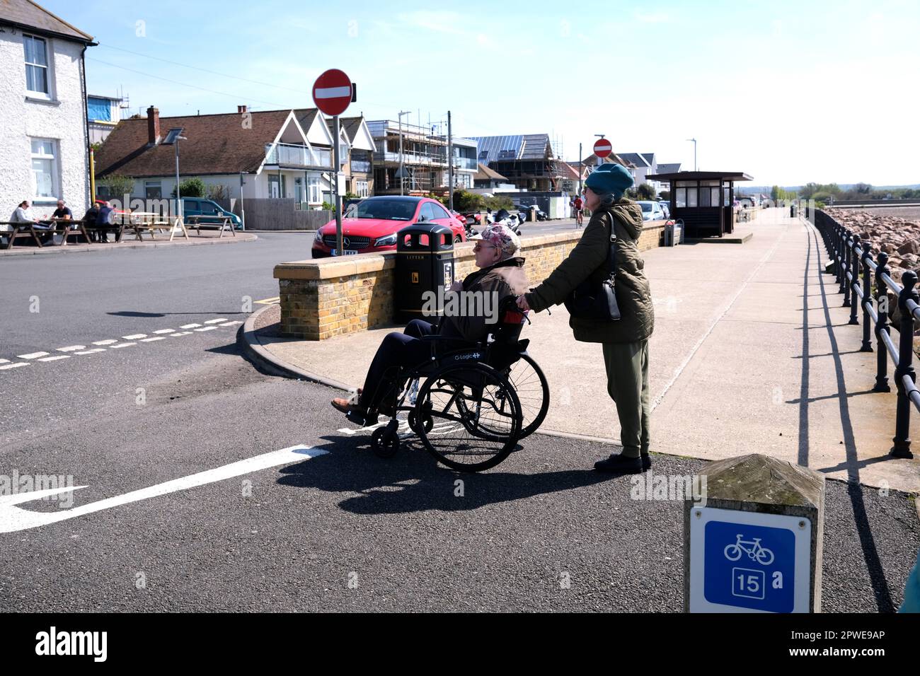 woman in a wheelchair with a woman carer,hampton-on-sea,isle of thanet,east kent,uk april 2023 Stock Photo