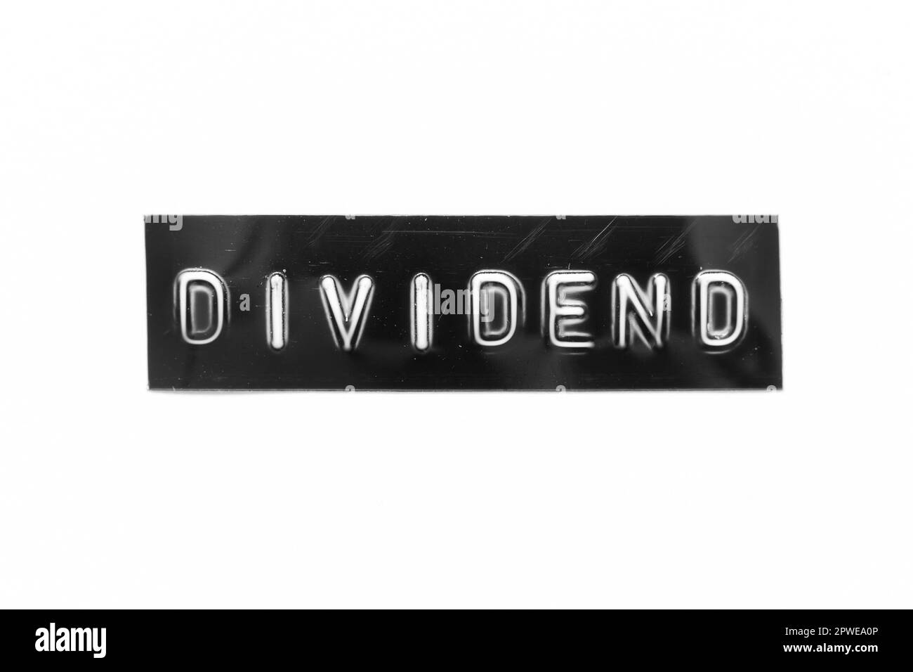 Black color banner that have embossed letter with word dividend on white paper background Stock Photo