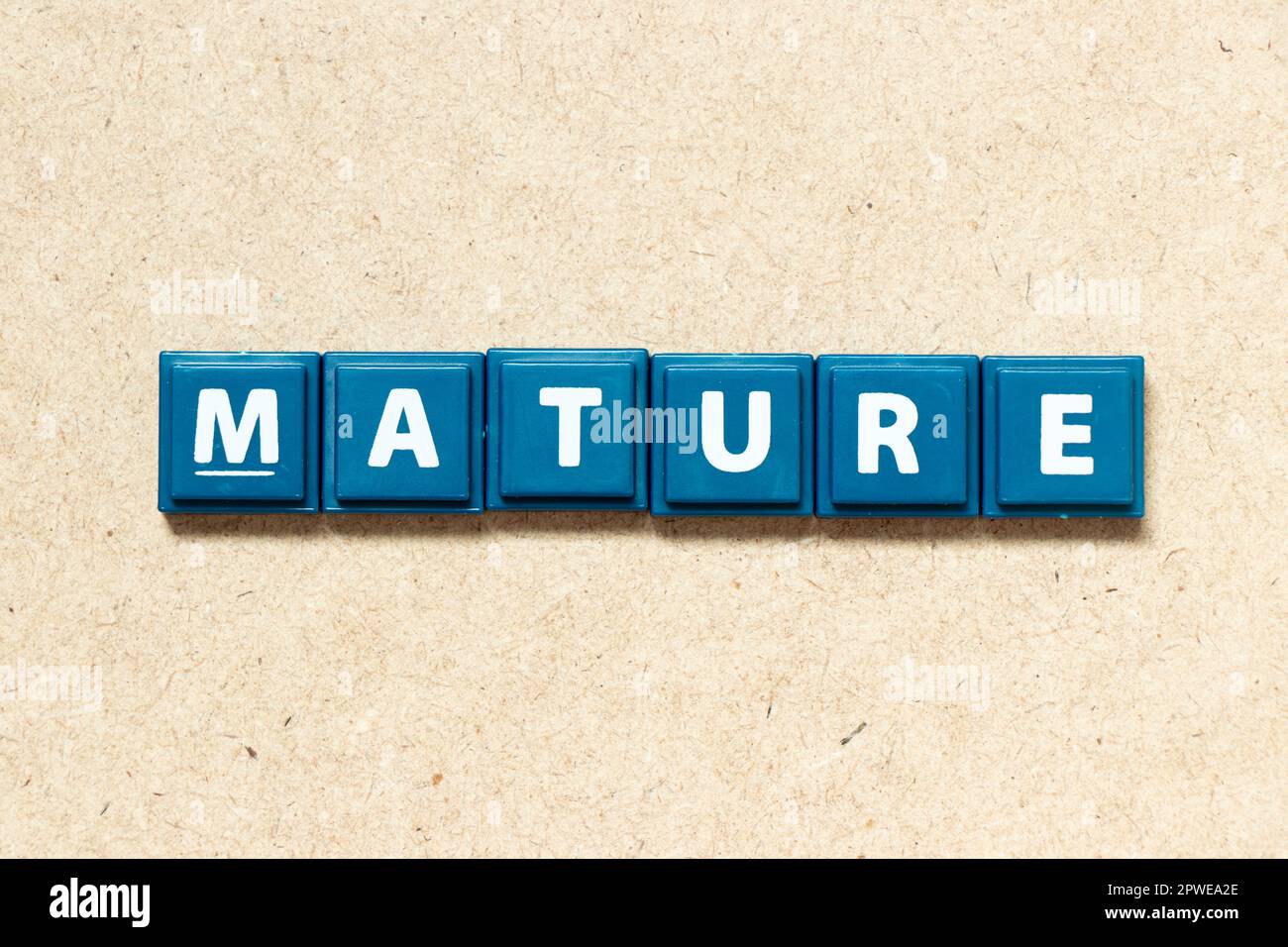 Tile alphabet letter in word mature on wood background Stock Photo - Alamy