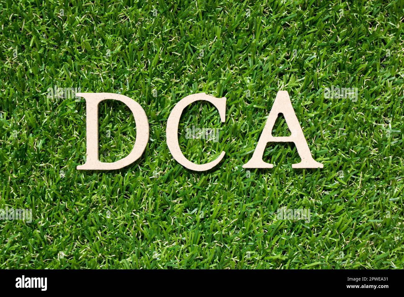 Wood alphabet letter in word DCA (Abbreviation of Dollarcost averaging