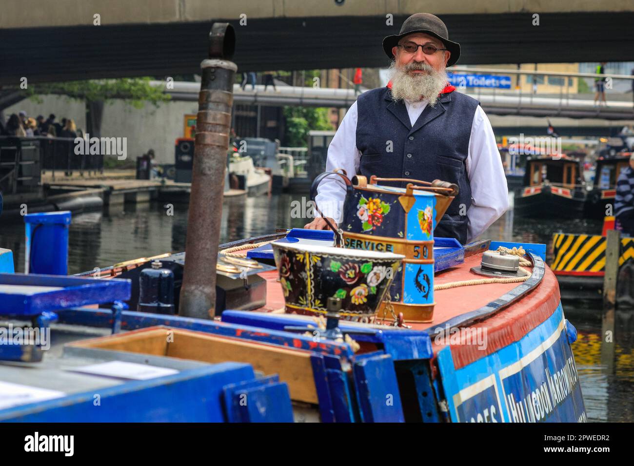 London, UK, 30th April 2023. Peter, a volunteer on the "Pisces" dressed up in a traditional boating outfit, represents the Hillingdon Narrowboat Association, a charity that takes disadvantages people on boat trips. Narrowboats, barges and canal boats once again take part in the IWA Canalway Cavalcade festival in Little Venice Organised by the Inland Waterways Association (IWA), IWA Canalway Cavalcade has its 40th anniversary this year, celebrating boat life on the waterways with a boat pageant, music, stalls and family entertainment along the Grand Union Canal. Stock Photo