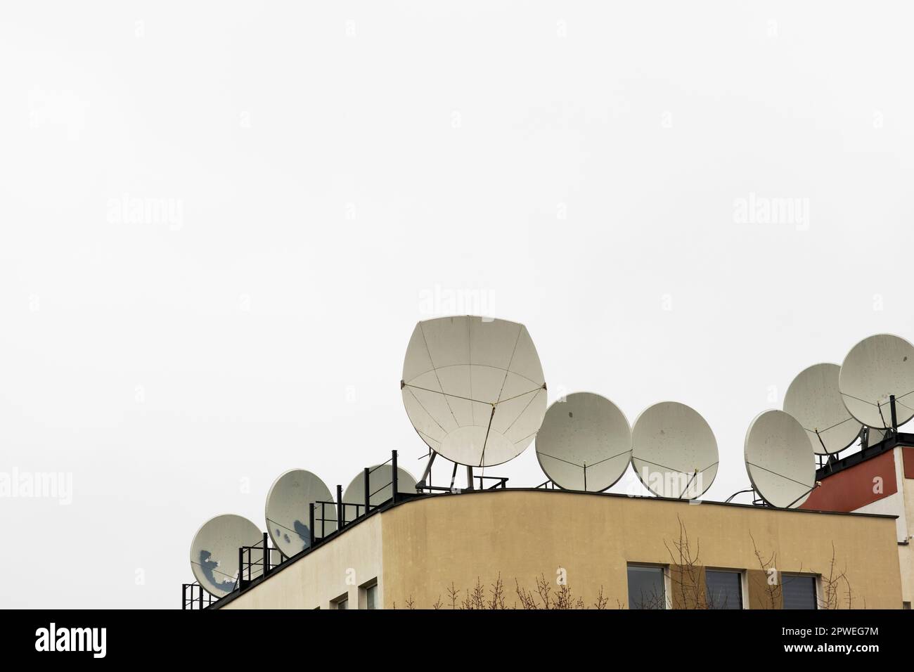 Many satellite dishes on the roof of the building Stock Photo Alamy