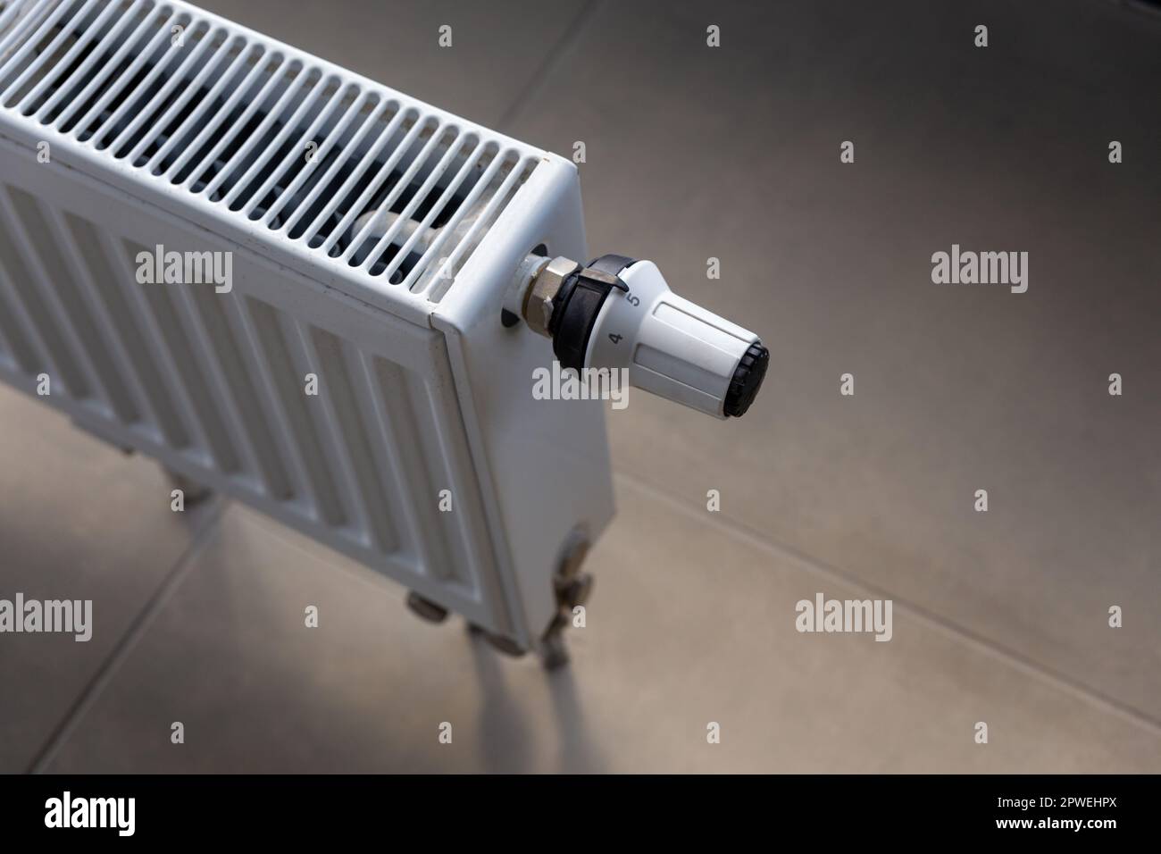 Close-up of white central heating floor radiator with a power regulator in the maximum position. Stock Photo