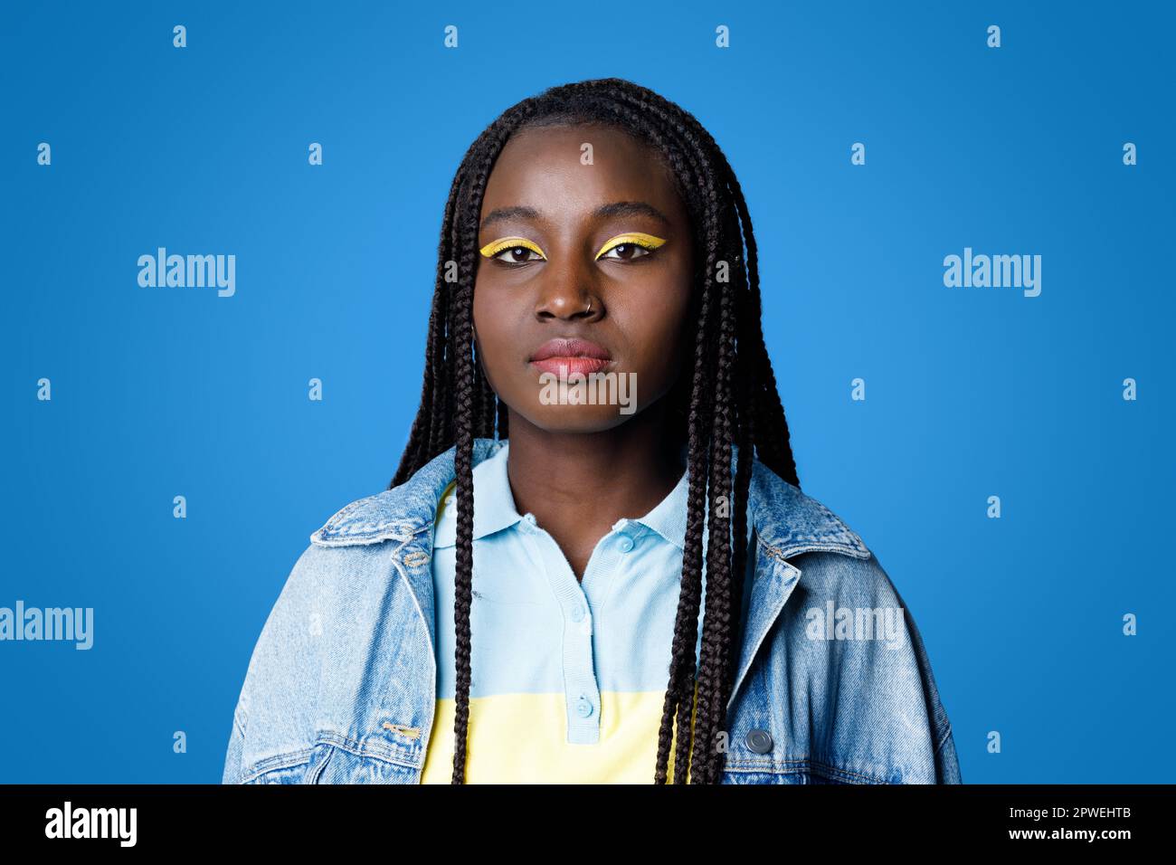 Cool stylish young black woman posing on blue Stock Photo
